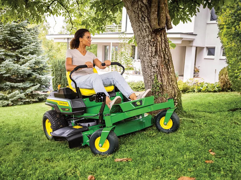 Zero-turn mower on a backyard lawn
